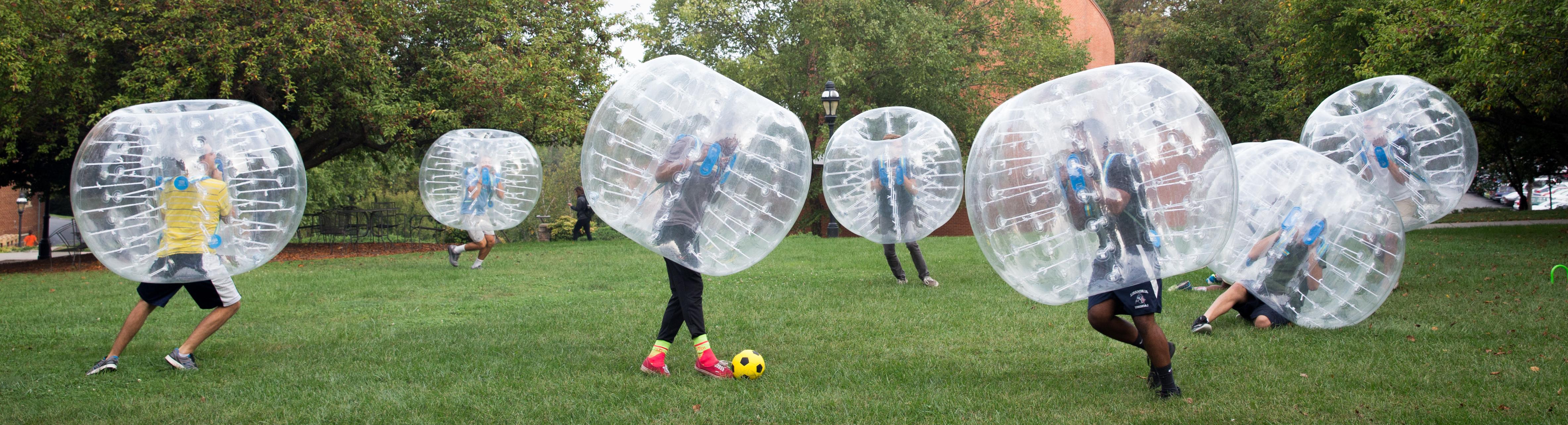 Students playing bubble soccer.